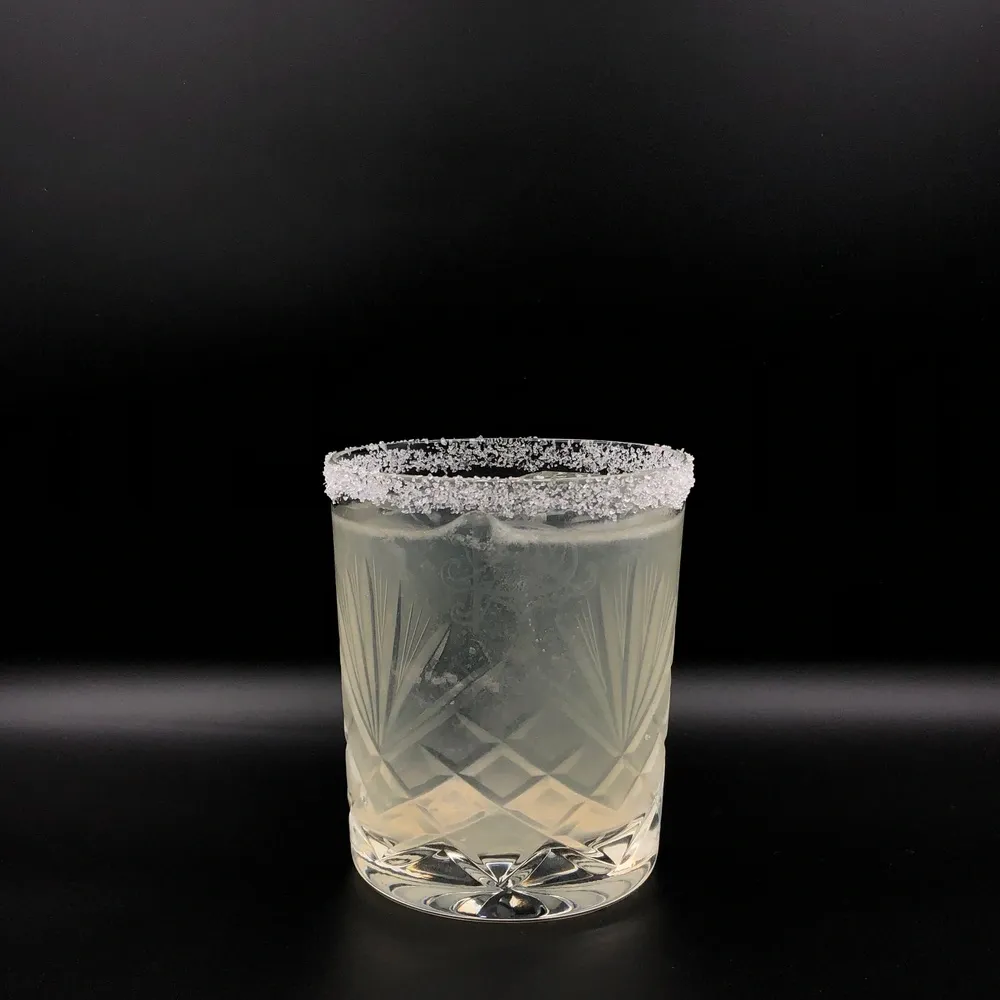 A Tommy's Margarita in a salt-rimmed glass